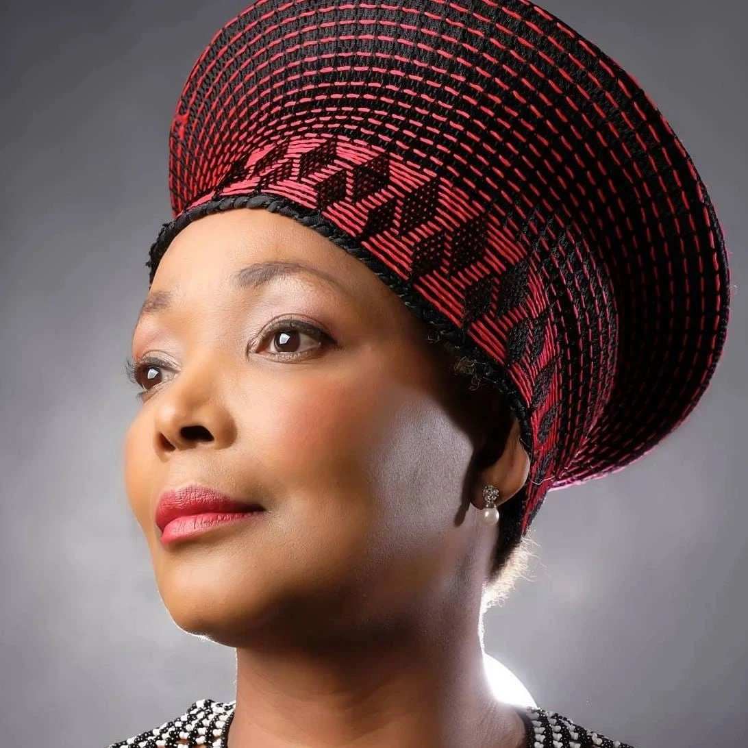 HRH Princess Zama-Zulu Shange wearing a red and black traditional Zulu headdress